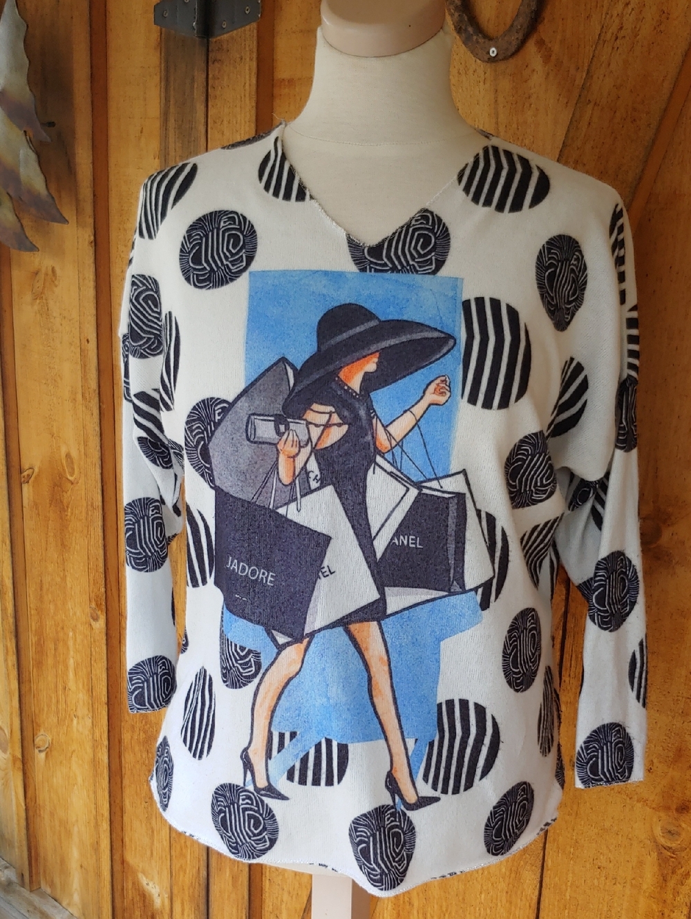 White V-Neck Sweater with Black Graphic and Blue Accent